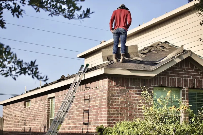Professional roofer working on a residential roof in East Brunswick